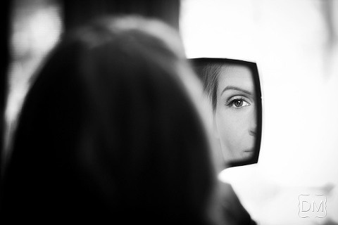 Bride looking through mirror.