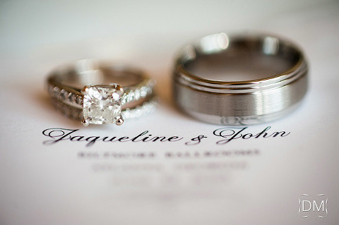 Wedding rings atop the wedding program at Biltmore Ballrooms photographed by The Decisive Moment.