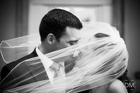 Bride and groom embrace in front of the Biltmore Ballrooms. Atlanta wedding photography by The Decisive Moment.