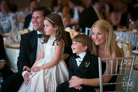 Family looking on to the first dance at this ballroom wedding