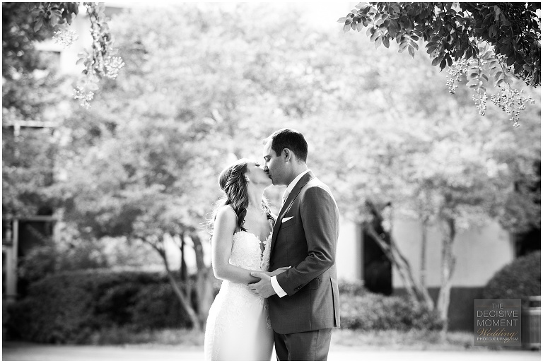 Bride and groom share a pre-ceremony kiss black and white image by Decisive Moment Atlanta Wedding Photography