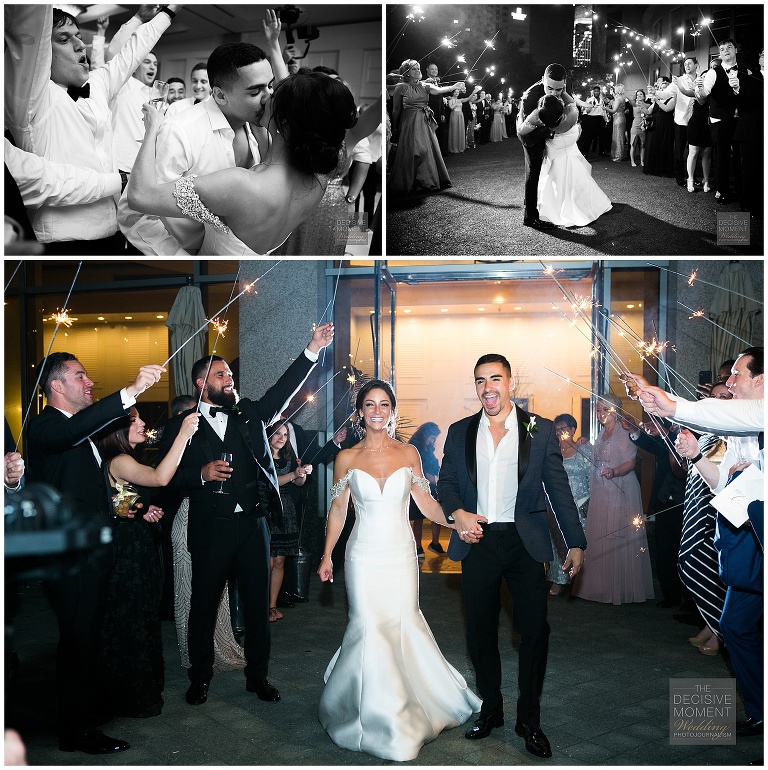 Bride and groom share a kiss before final departure through a sparkler tunnel